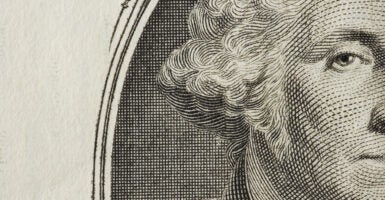 A closeup of a George Washington on a dollar bill