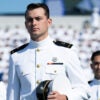 Naval Academy midshipmen line up for graduation in white uniforms