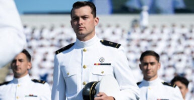 Naval Academy midshipmen line up for graduation in white uniforms