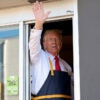 Donald Trump waves from McDonald's window