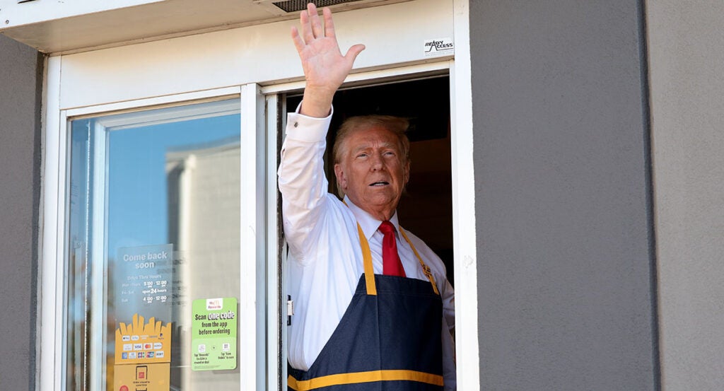 Donald Trump waves from McDonald's window