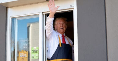 Donald Trump waves from McDonald's window