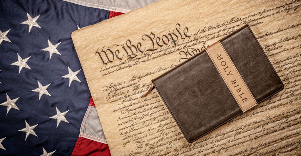 The Bible lying on top of the Constitution, which is lying on top of the American flag.