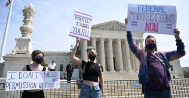 Transgender activists holding up signs for transgender 