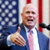 Now the NATO ambassador-designate, Matthew Whitaker campaigns for Donald Trump in Montana on Aug. 9 with a U.S. flag in the background.