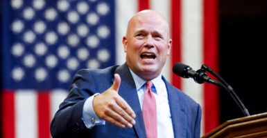 Now the NATO ambassador-designate, Matthew Whitaker campaigns for Donald Trump in Montana on Aug. 9 with a U.S. flag in the background.