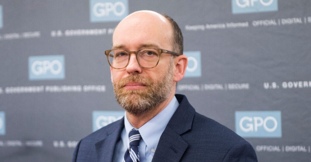 OMB director-designate Russ Vought in blue suit and striped tie