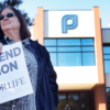 An anti-abortion protester holds a vigil outside of a Planned Parenthood office Holding a sign that says "Prayed to end abortion. 40 Days For Life."