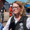 Deanne Criswell scowls in a vest with the FEMA logo