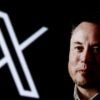 Elon Musk is posing next to the X logo, what he rebranded Twitter after he bought it.