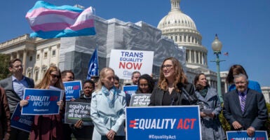 Sarah McBride in front of trans flag