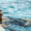 Young woman relaxing in pool.