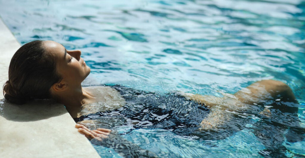 Young woman relaxing in pool.