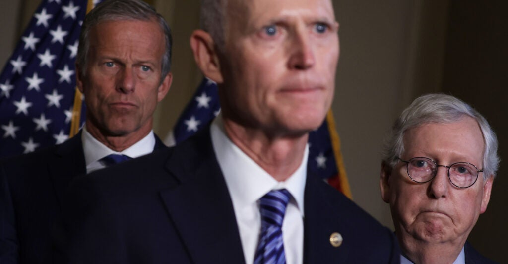 U.S. Sen. Rick Scott (R-FL) stands with Senate Minority Leader Sen. Mitch McConnell (R-KY) and Senate Minority Whip Sen. John Thune (R-SD).