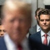 Matt Gaetz behind Donald Trump, both wearing suits