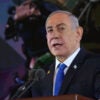 Israel's Prime Minister Benjamin Netanyahu, dressed in a black suit and a light blue necktie, speaks during a ceremony remembering the Hamas attack on Oct. 7, 2024.