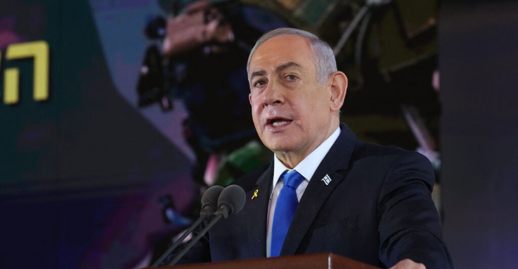 Israel's Prime Minister Benjamin Netanyahu, dressed in a black suit and a light blue necktie, speaks during a ceremony remembering the Hamas attack on Oct. 7, 2024.