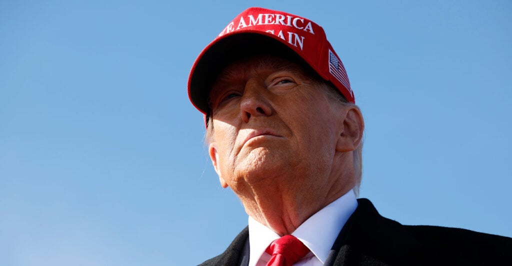 Donald Trump wearing a "Make America Great Again" hat.