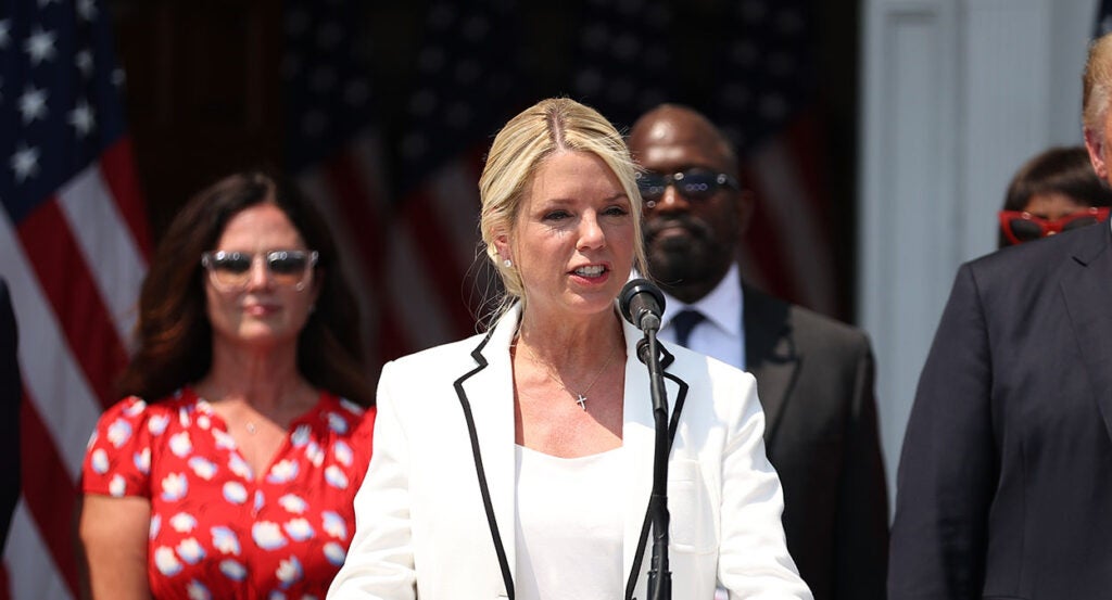 Pam Bondi speaks in white