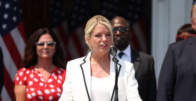 Pam Bondi speaks in white