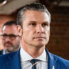 Pete Hegseth in a blue pin-stripe suit