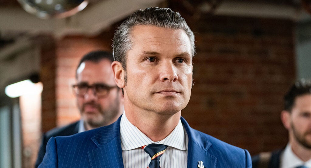 Pete Hegseth in a blue pin-stripe suit