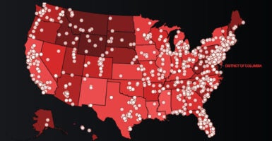 A map of the United States in different shades of red with white dots