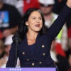 Tulsi Gabbard waves in a blue outfit