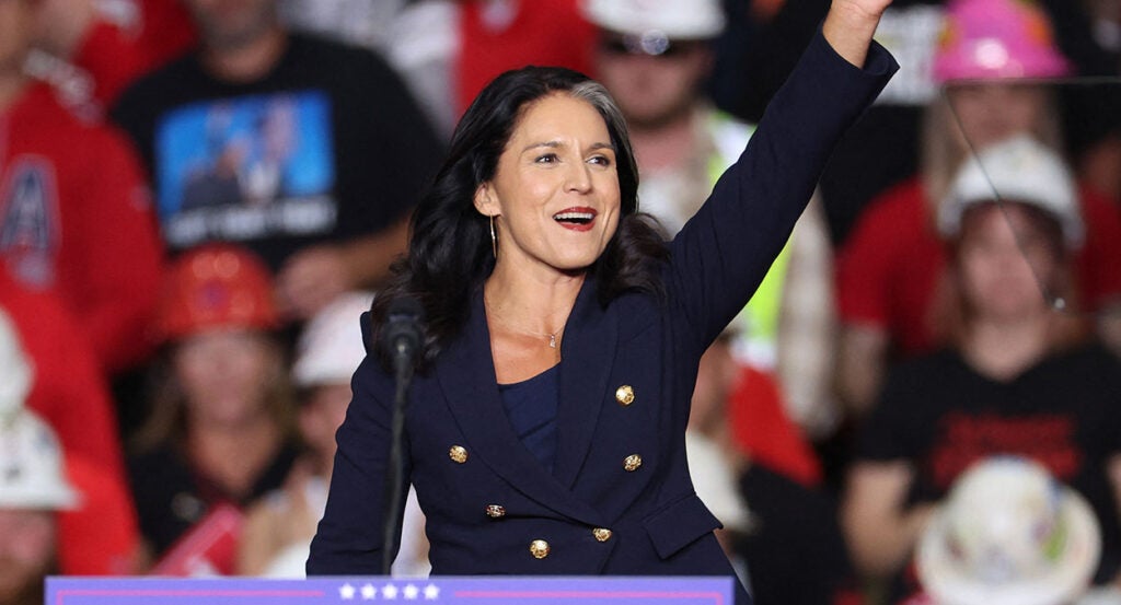 Tulsi Gabbard waves in a blue outfit