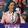 Tulsi Gabbard stands at a podium and speaks at a Donald Trump campaign rally