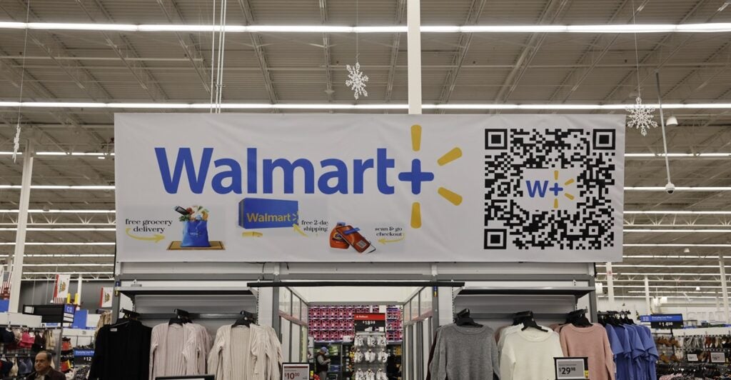 A large Walmart banner hangs in a supercenter.