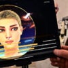 A female artificial intelligence character on a tablet screen with a humanoid robot on display in the background.