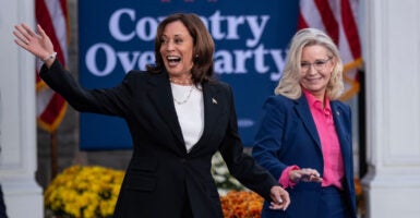 Kamala Harris and Liz Cheney smiling and greeting supporters at an event