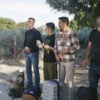 illegal immigrant men with luggage captured by border patrol in the desert stand for photos awaiting deportation