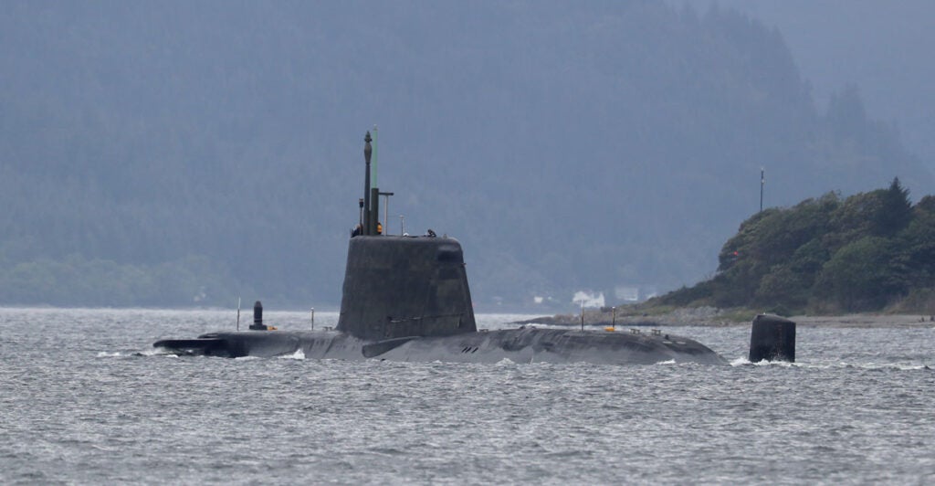 A British navy sub peeking out of the water near shore