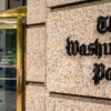 The marble front of the Washington Post building with the Washington Post logo