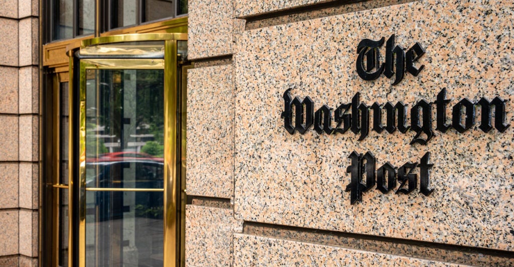 The marble front of the Washington Post building with the Washington Post logo