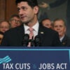 Then-House Speaker Paul Ryan behind a placard touting the 2017 Tax Cuts and Jobs Act