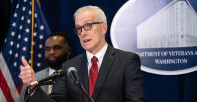 Denis McDonough, secretary of Veterans Affairs, in a white shirt and red tie