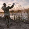 Texas National Guard soldiers install additional razor wire along the Rio Grande on Jan. 10 in Eagle Pass, Texas.