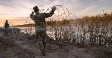 Texas National Guard soldiers install additional razor wire along the Rio Grande on Jan. 10 in Eagle Pass, Texas.