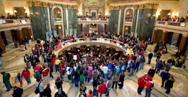 An aerial view of the Wisconsin state Capitol Rotunda filled with demonstrators in February 2011