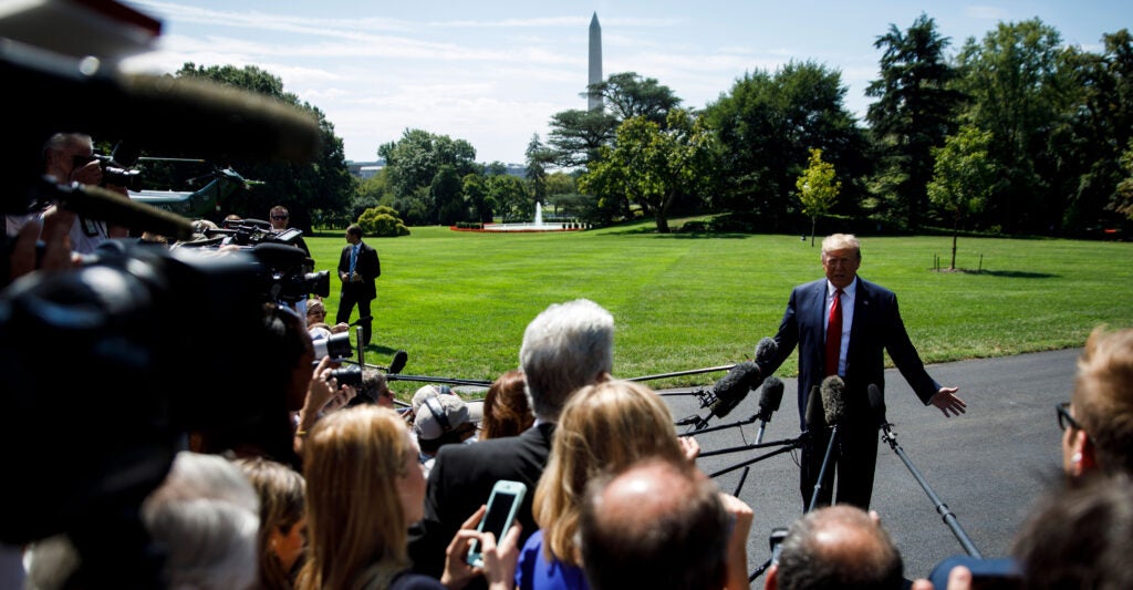 President Donald Trump speaking to a gaggle of reporters outside the White House