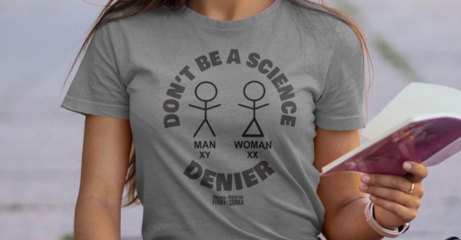 A young woman in a gray T-shirt that reads, "Don't Be a Science Denier"