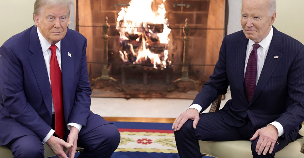 President Joe Biden, on the right, meets with President-elect Donald Trump in front of a fire in the Oval Office on Nov. 13.