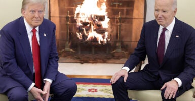 President Joe Biden, on the right, meets with President-elect Donald Trump in front of a fire in the Oval Office on Nov. 13.