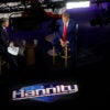 Sean Hannity and Donald Trump sitting on the set of Hannity's Fox News show.