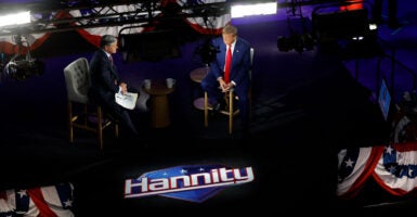 Sean Hannity and Donald Trump sitting on the set of Hannity's Fox News show.