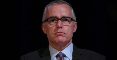 Andrew McCabe in a suit stares ahead