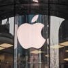 The Apple logo appears on a glass window of a building in China in 2024.